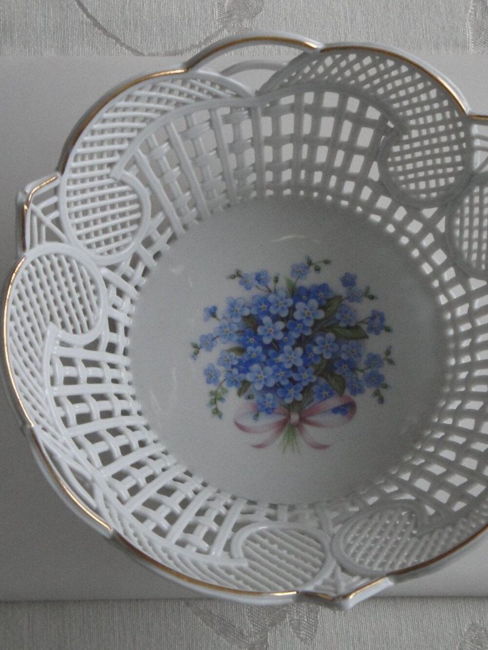Vintage openwork plate with a bouquet of forget-me-nots